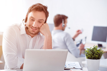 Positive  man sitting at the table  