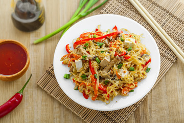 Asian meal made of rice noodles, tofu, vegetables and shiitake mushrooms. Traditional Oriental cuisine meal. Top view.