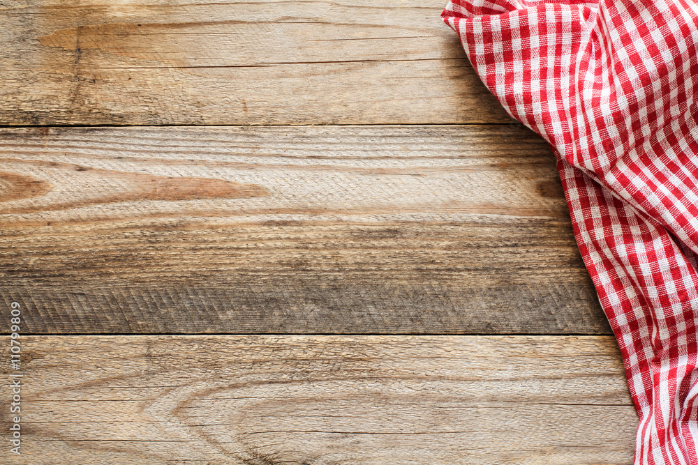 Wall mural Wooden background with textile / Cooking food / pizza wooden table background with red and white textile. Copy space for text