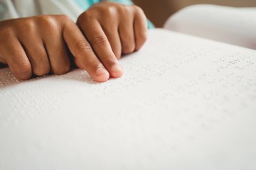 Girl using braille to read