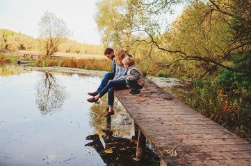 happy family spending time together outdoor. Lifestyle capture, rural cozy scene. Father, mother...