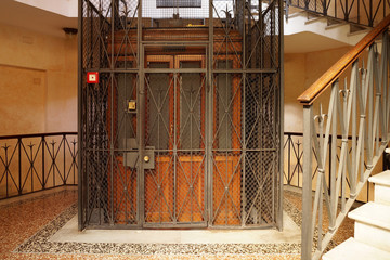 Old Wooden Elevator in a Metal Shaft - obrazy, fototapety, plakaty