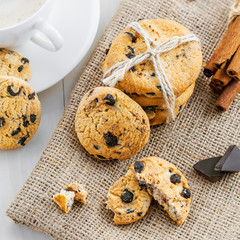 Baked biscuits with chocolate. Coffee break with homemade cookies. Top view, close-up.