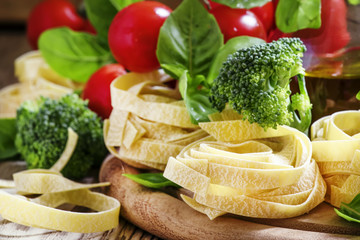 Ingredients for cooking pasta fettuccine with broccoli, tomatoes