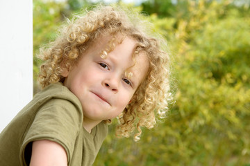 portrait of a young boy with blond curly hair
