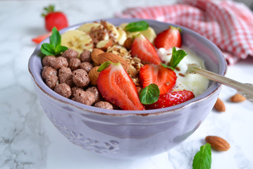 smoothie in a bowl for breakfast with yogurt, strawberries, oatm
