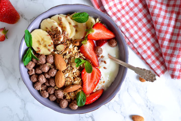 smoothie in a bowl for breakfast with yogurt, strawberries, oatm