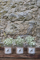 Fototapeta na wymiar Decorated Vintage jars with Gypsophila flowers on stone background