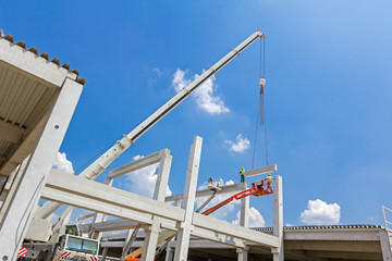 Mobile crane is carry concrete joist to assembly huge hall.