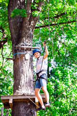 Obraz premium adventure climbing high wire park - people on course in mountain
