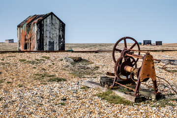 Fototapeta premium Old shack and rusty machinery on Dungeness beach