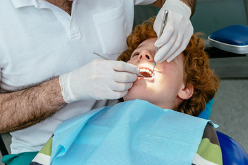 The doctor inspects the baby teeth