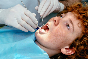 The doctor inspects the baby teeth