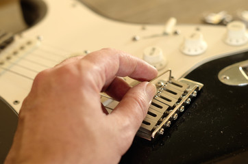 Hand close-up. Tuning a vintage guitar. 