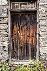 Fototapeta na wymiar old wooden door stone wall