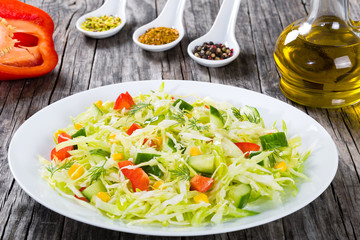 spring cabbage salad with bell pepper, corn and dill, close-up