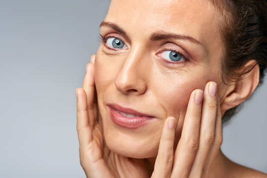 skin care with middle age woman in studio