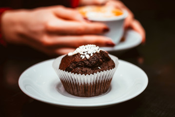 Chocolate muffin on a table in a cafe