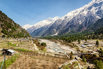 Fototapeta na wymiar Valley view in Himalayas with river and wooden bridge. Sangla 