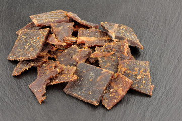 Beef Jerky On Slate Stone Background