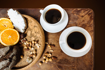 Two white cups with espresso on wood table
