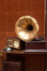 Antique gramophone with golden horn and radio