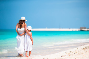 Fototapeta na wymiar Mom and girl on beach tropical vacation