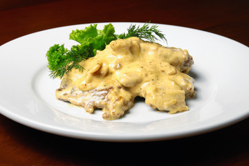 Veal with cheese sauce on plete