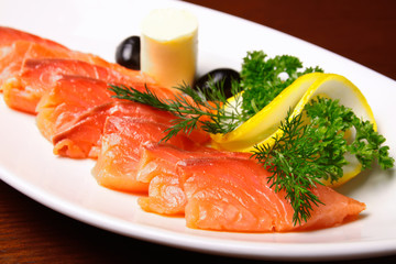 Slices of salmon with lemon and butter