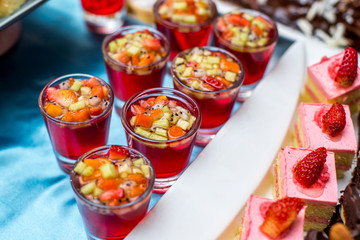 Fototapeta na wymiar Cocktail with fruit pieces in a glass
