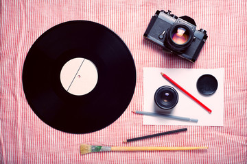 Obraz premium Background with vinyl and old camera on striped background