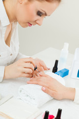 Obraz na płótnie Canvas Female beautician making nails.