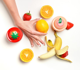 Hands with fruits orange lemon banana peach and strawberry