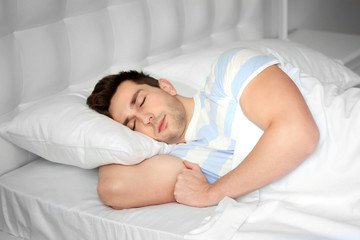 Young man sleeping in bed