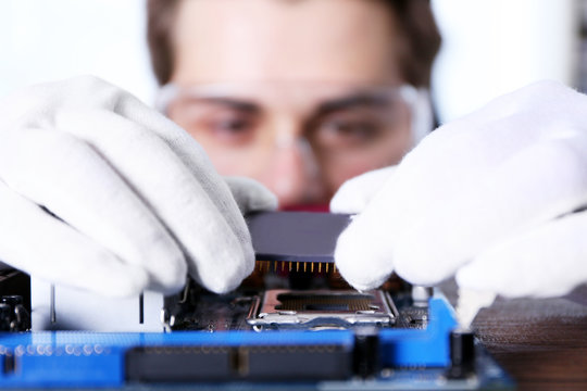 Man fixing electronic circuits closeup