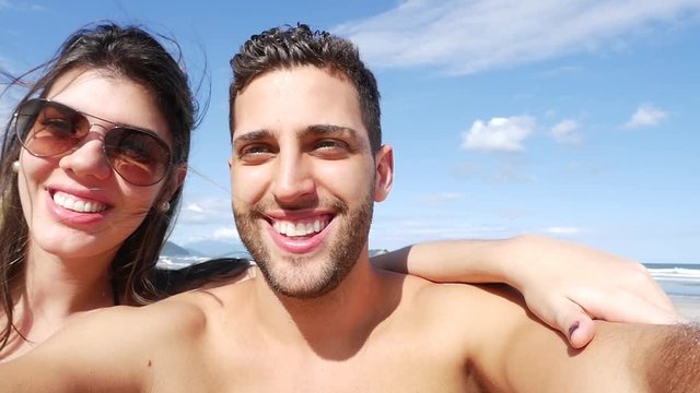 Couple having fun and taking selfies on the beach, Brazil in Slow Motion