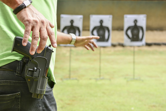 Man holding a gun ready to shoot