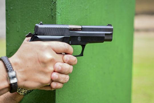 Man hold a gun aiming ready to shoot.