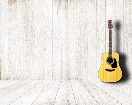 Acoustic guitar in vintage white wood room.