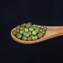 green beans in a wooden spoon