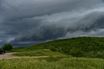 Heavy, dark clouds threatening a thunderstorm over the forest
