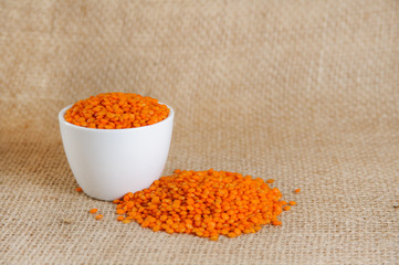 red lentils on burlap backbround