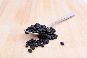 Fototapeta na wymiar Black soybeans and spoon 