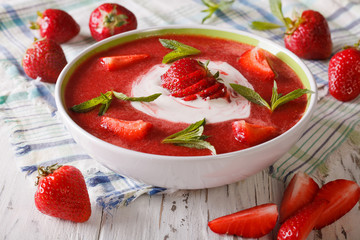 Soup of fresh strawberry with yogurt close up in a bowl. horizontal
