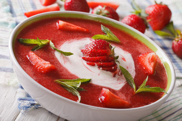 Strawberry soup with mint and sour cream close-up. horizontal
