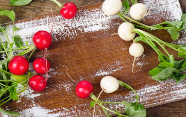 Raw radishes on a wooden board.