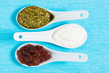 Pesto Horseradish chutney on blue crepe paper.