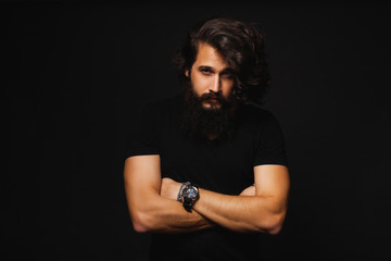 Brutal bearded man outdoor studio portrait.Cool businessman portrait outdoor,muscular body,rock n roll singer,trendy hairstyle man.handsome guy relaxing at grass