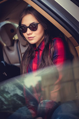 Brunette woman in a car.