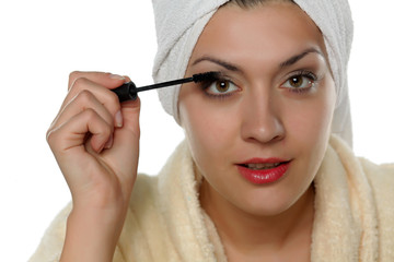 young beautiful woman apply mascara
